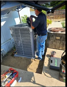 Technician wiring and commissioning a new air conditioning unit in Hemet CA